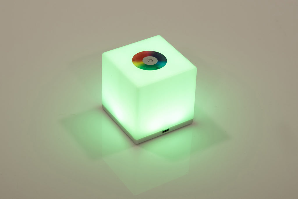 Mini cube LED lamp glowing green with circular top lens