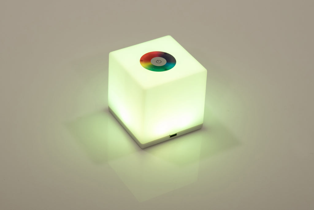 Mini cube LED lamp glowing green with circular top lens