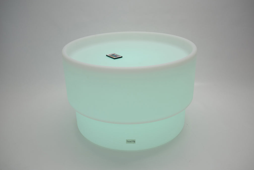 Round tabletop light, mint green glow with white rim and small top emblem