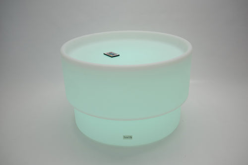 Round tabletop light, mint green glow with white rim and small top emblem