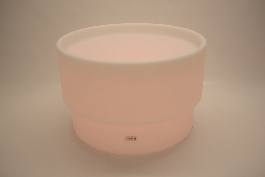 Round tabletop light, soft peach glow with white rim and smooth cylindrical base