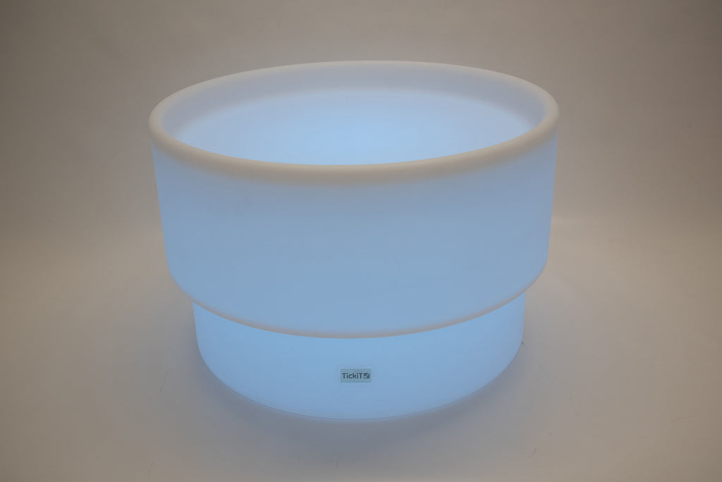 Round tabletop light, light blue glow with white rim and smooth cylindrical shape
