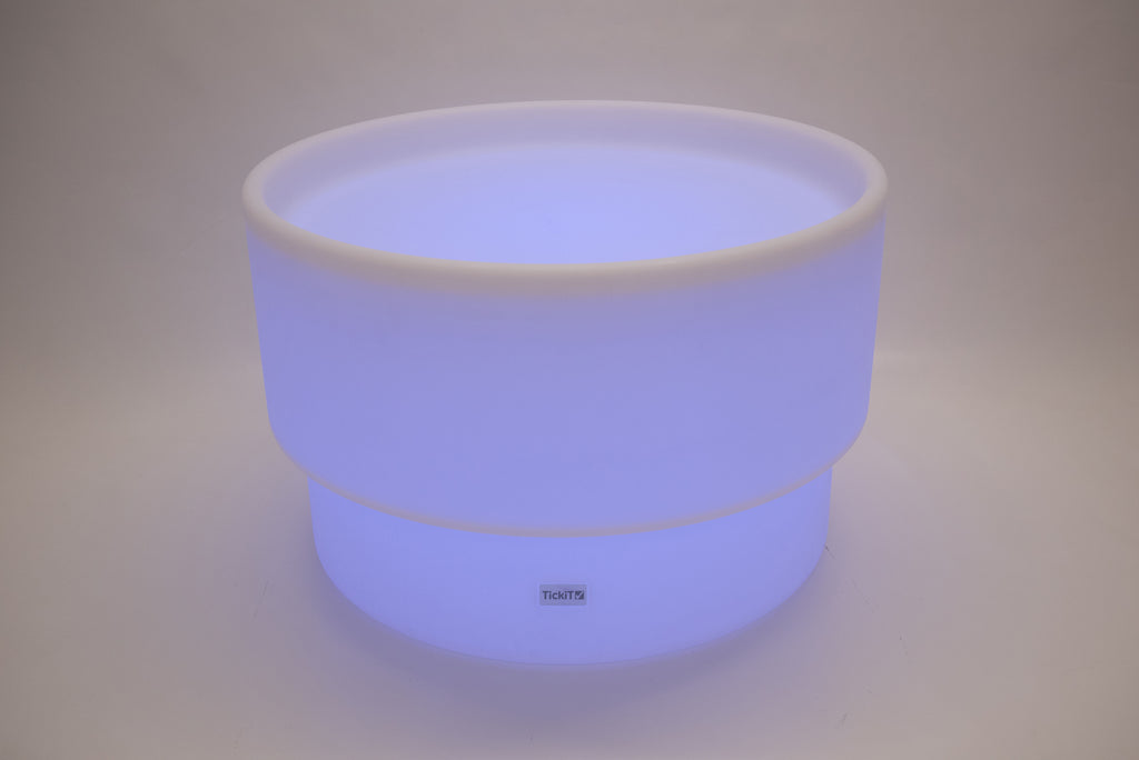 Round tabletop light, bright blue-violet glow with white rim and smooth sides