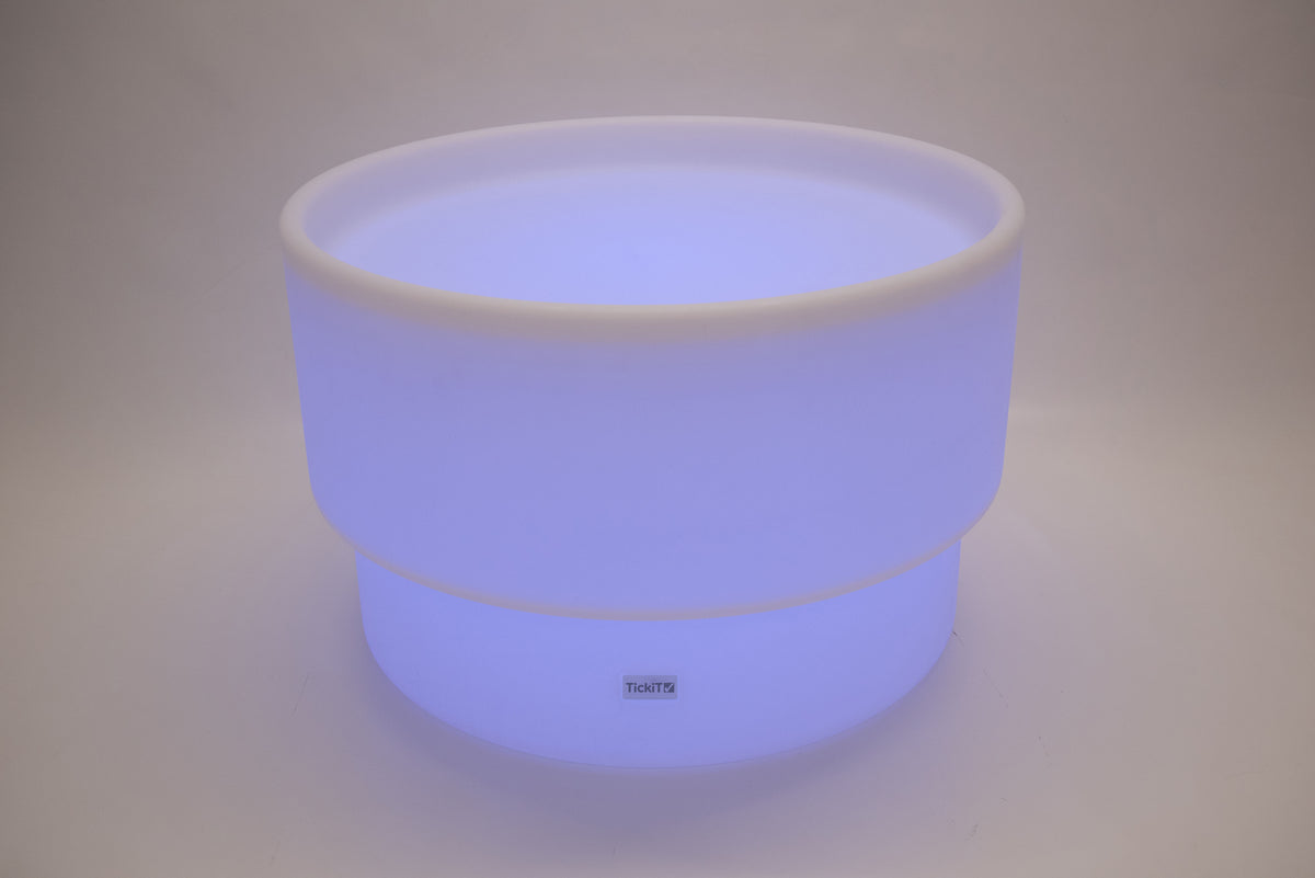 Round tabletop light, bright blue-violet glow with white rim and smooth sides