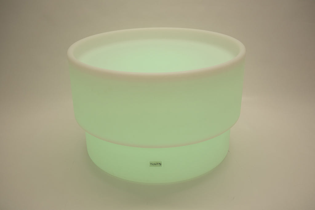 Round tabletop light, pale green glow with white rim and smooth cylindrical body