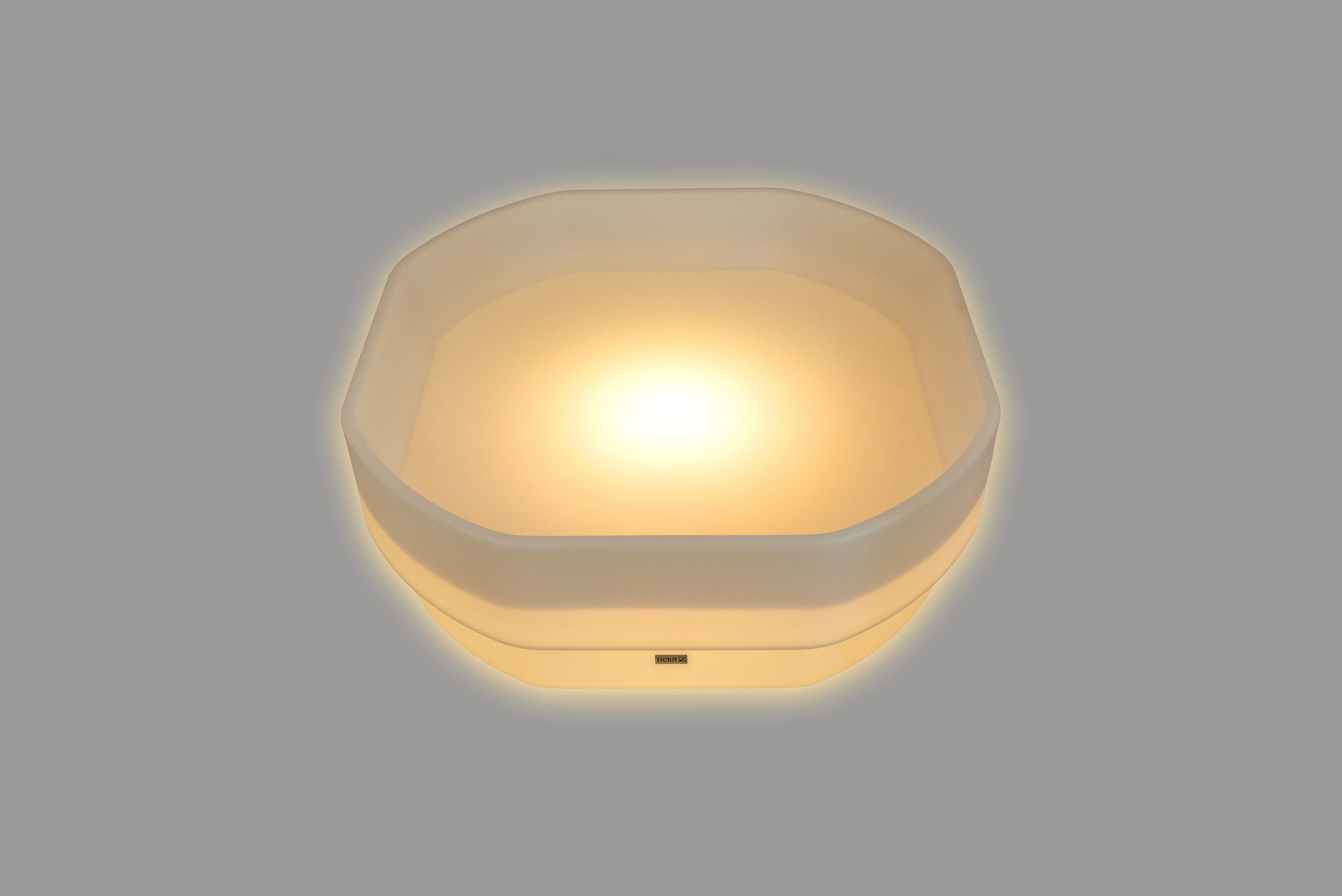 Hexagonal LED glow table with amber light and translucent outer rim