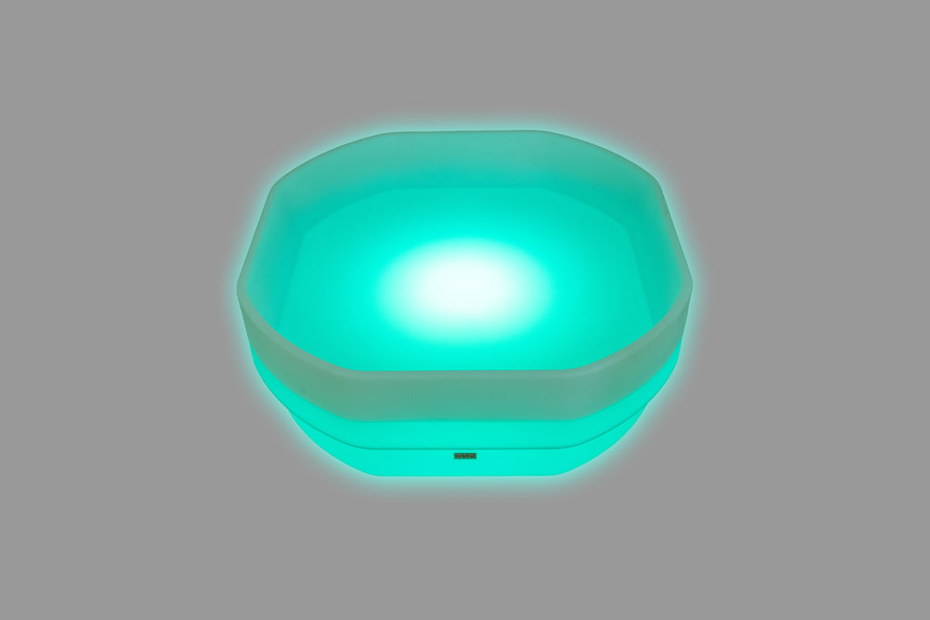 Hexagonal LED glow table with bright teal-blue light and glowing rim
