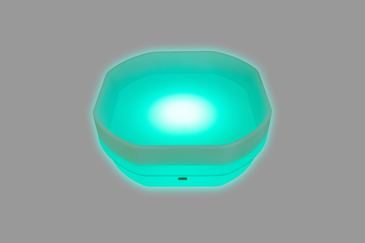 Hexagonal LED glow table with bright teal-blue light and glowing rim