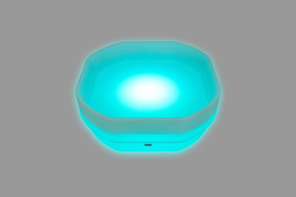 Hexagonal LED glow table with vivid cyan-blue light and glowing base