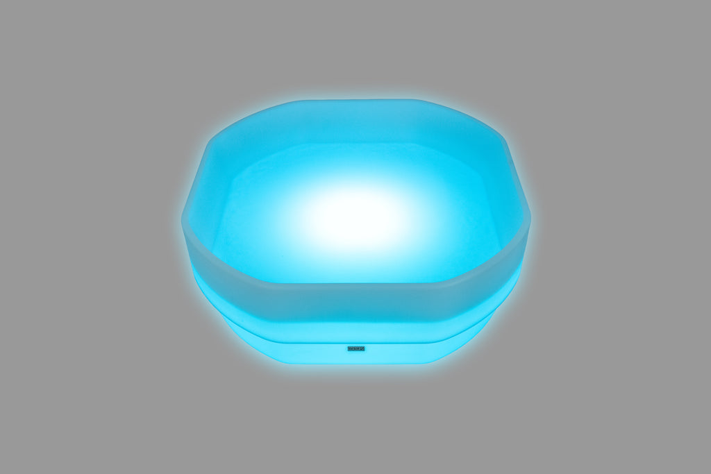 Hexagonal LED glow table with electric blue light and translucent outer rim
