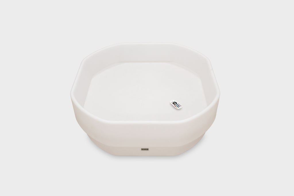 White hexagonal glow table with small power indicator on front