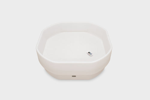 White hexagonal glow table with small power indicator on front