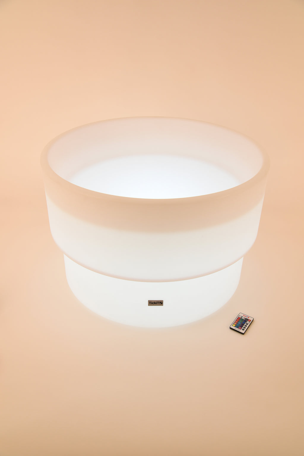 Glowing white circular water table with LED base