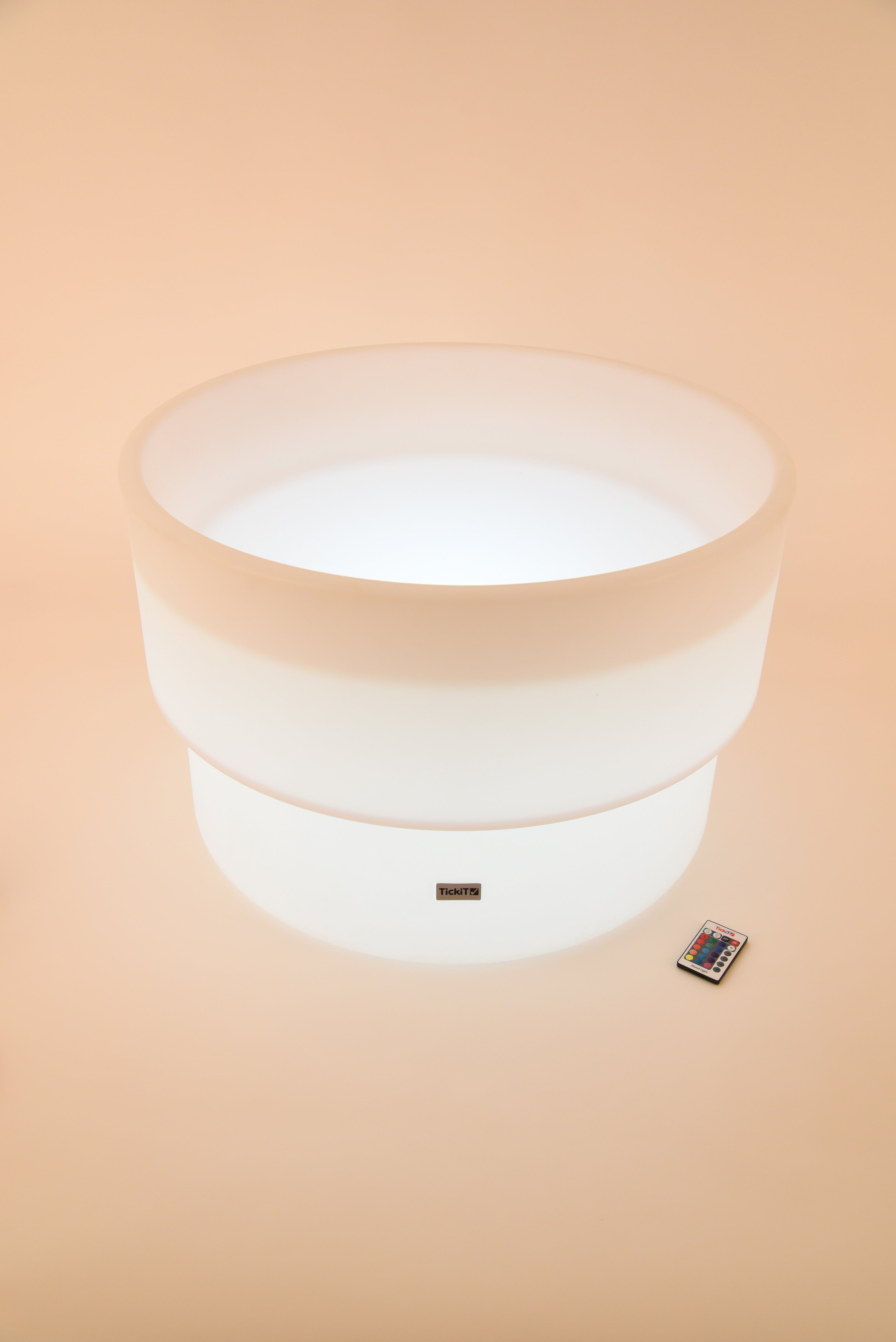 Glowing white circular water table with LED base