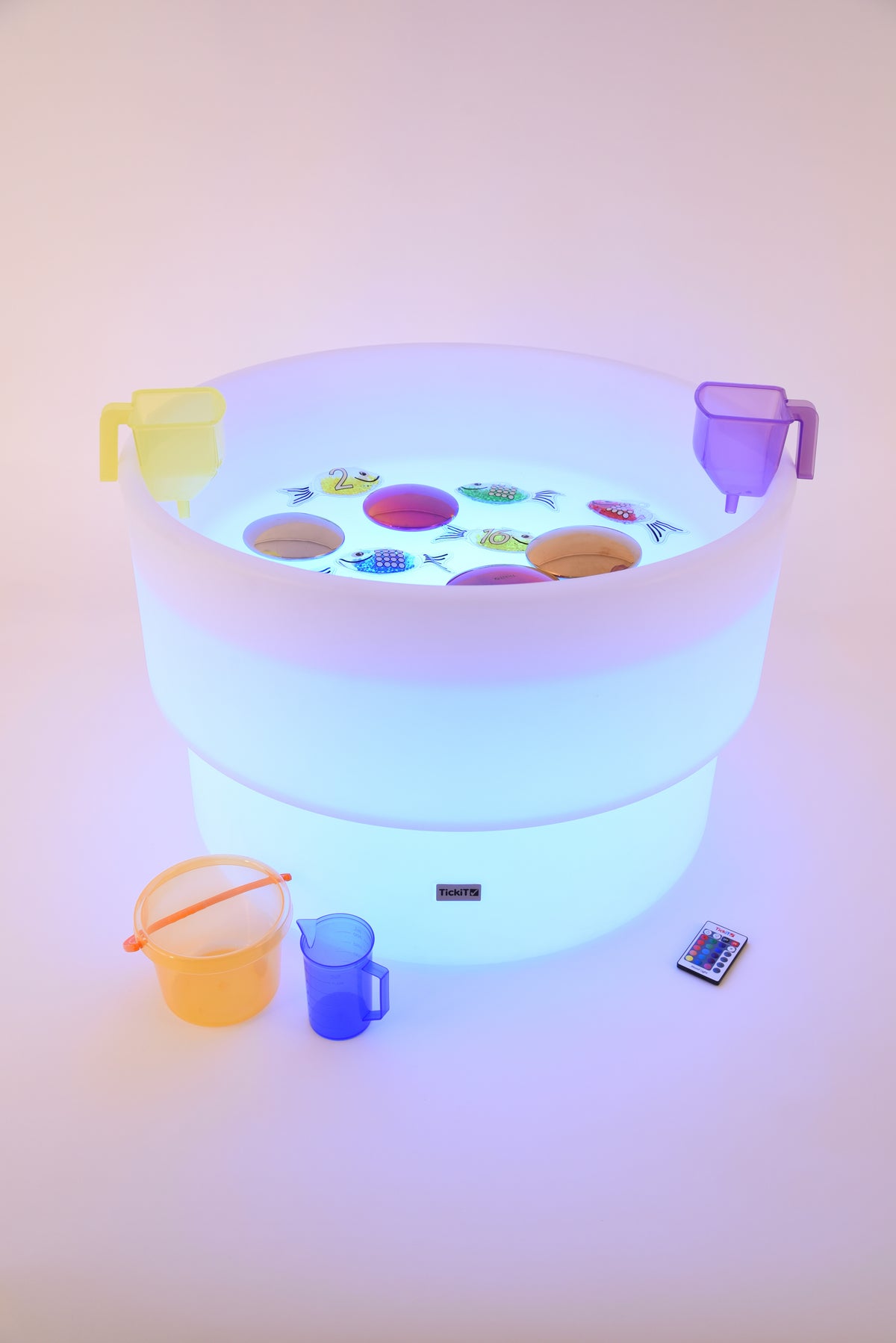 Glowing water table with colorful light, side handles, and play accessories