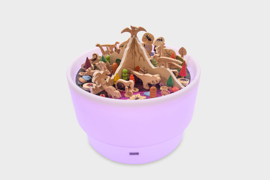 Purple dinosaur playset in a round tray filled with mixed prehistoric figures