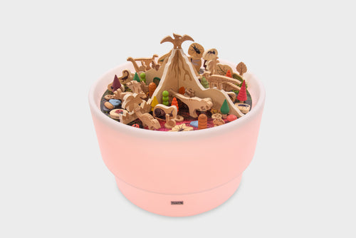 Light pink dinosaur playset in a round tray filled with mixed prehistoric figures