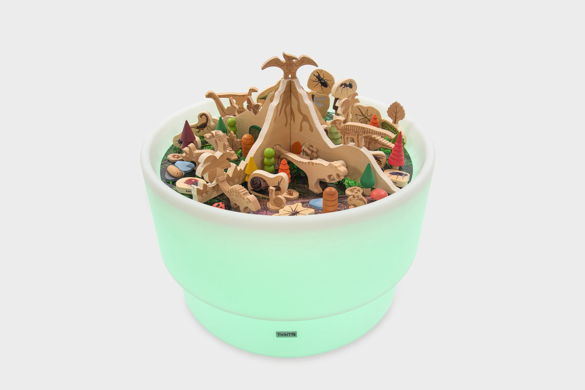 Mint-colored dinosaur playset in a round tray with mixed prehistoric figures