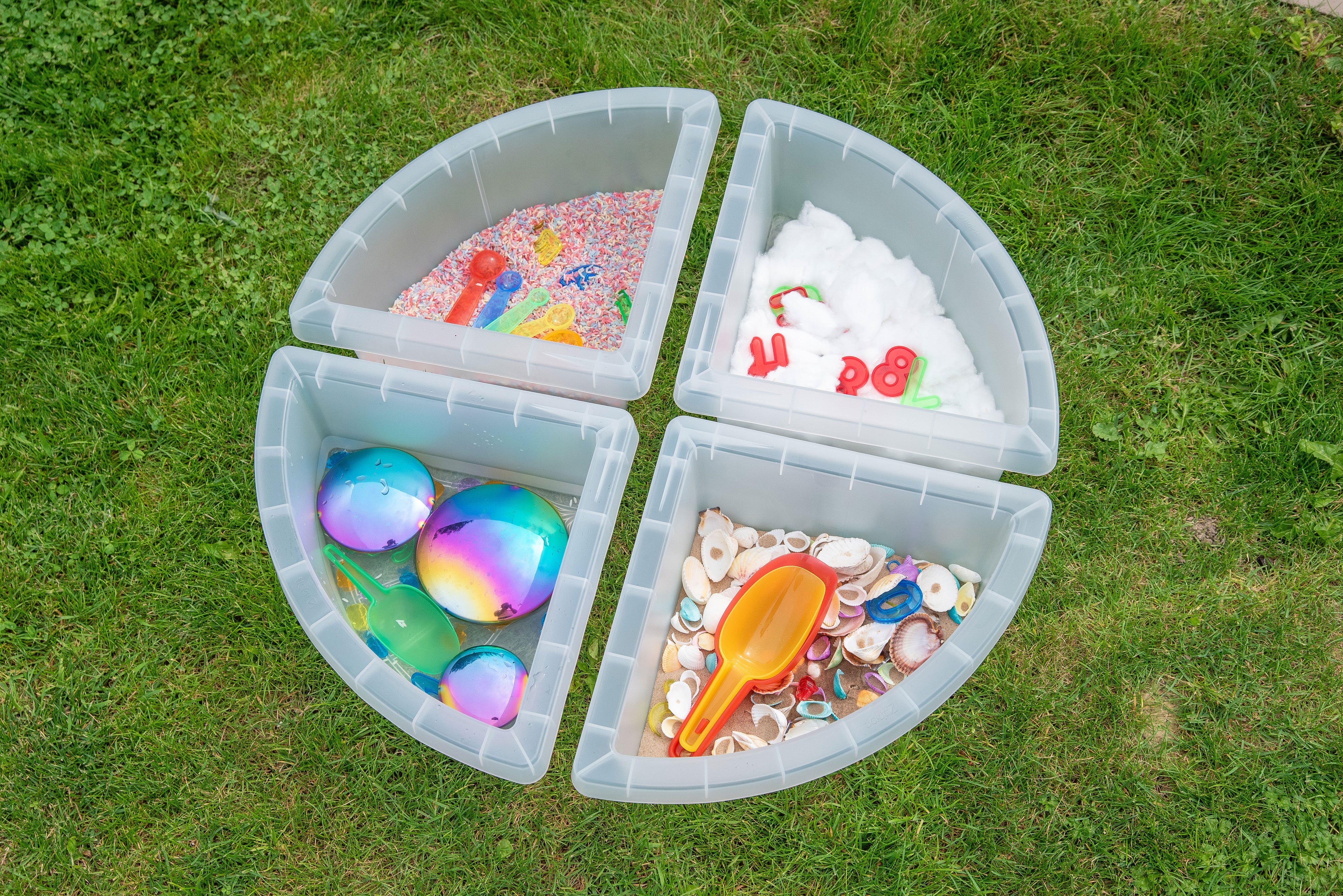 Overhead round four-quadrant clear tray with assorted toys placed in each section