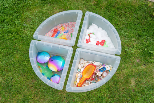 Overhead round four-quadrant clear tray with assorted toys placed in each section