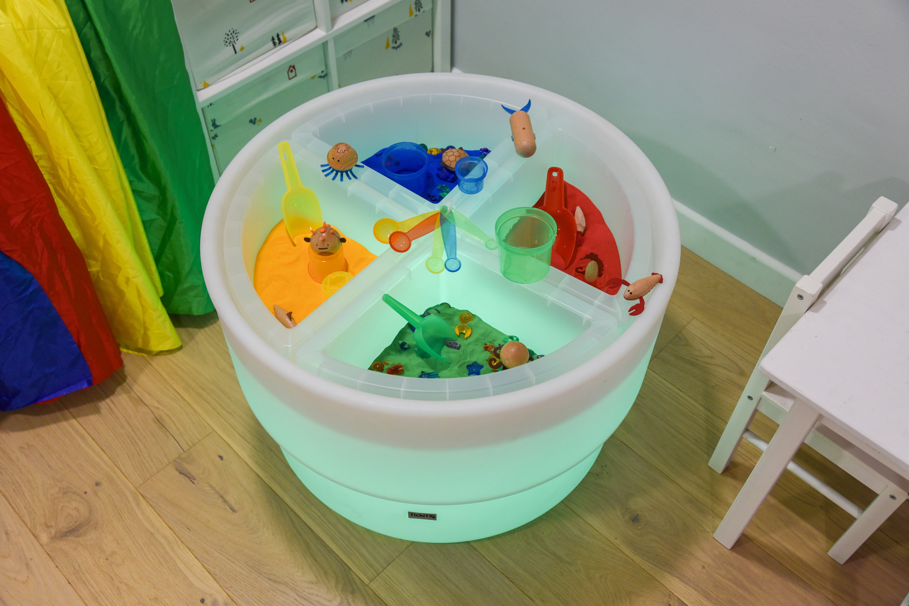 White round quadrant tray with four transparent compartments, visible items in each section