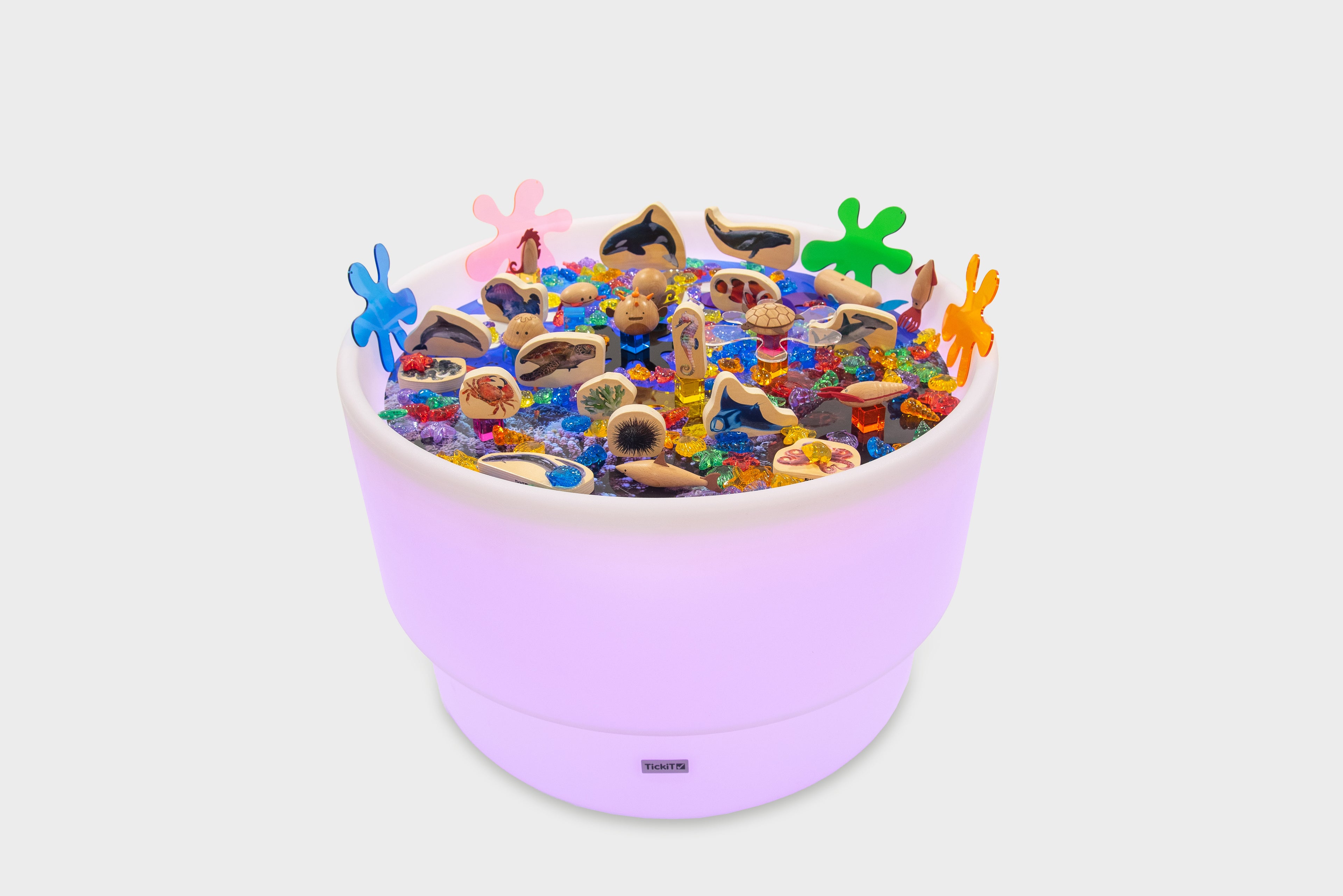Pastel purple sea-themed table bundle filled with ocean animal toys and shells