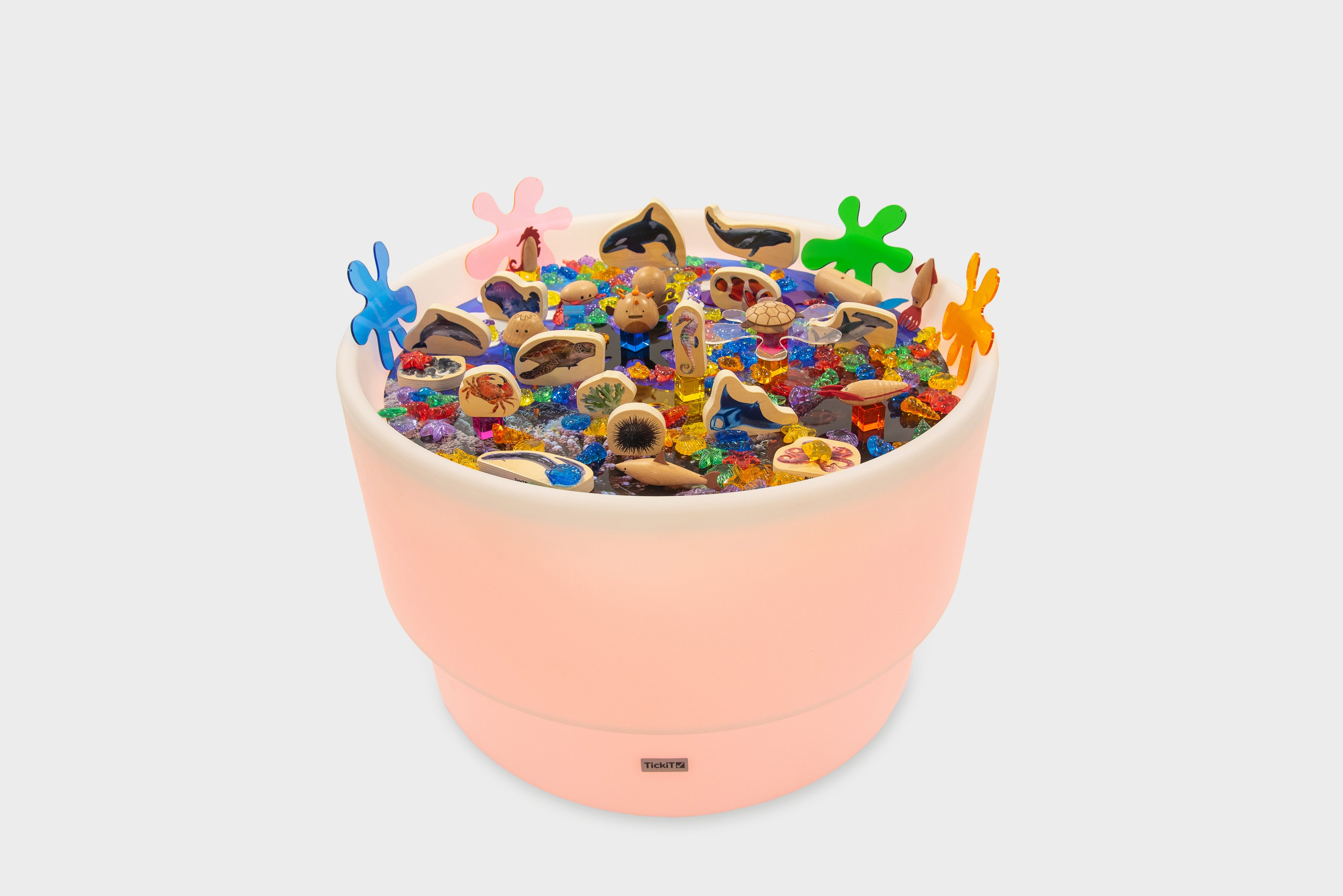 Pastel peach sea-themed table bundle filled with ocean animal toys and shells