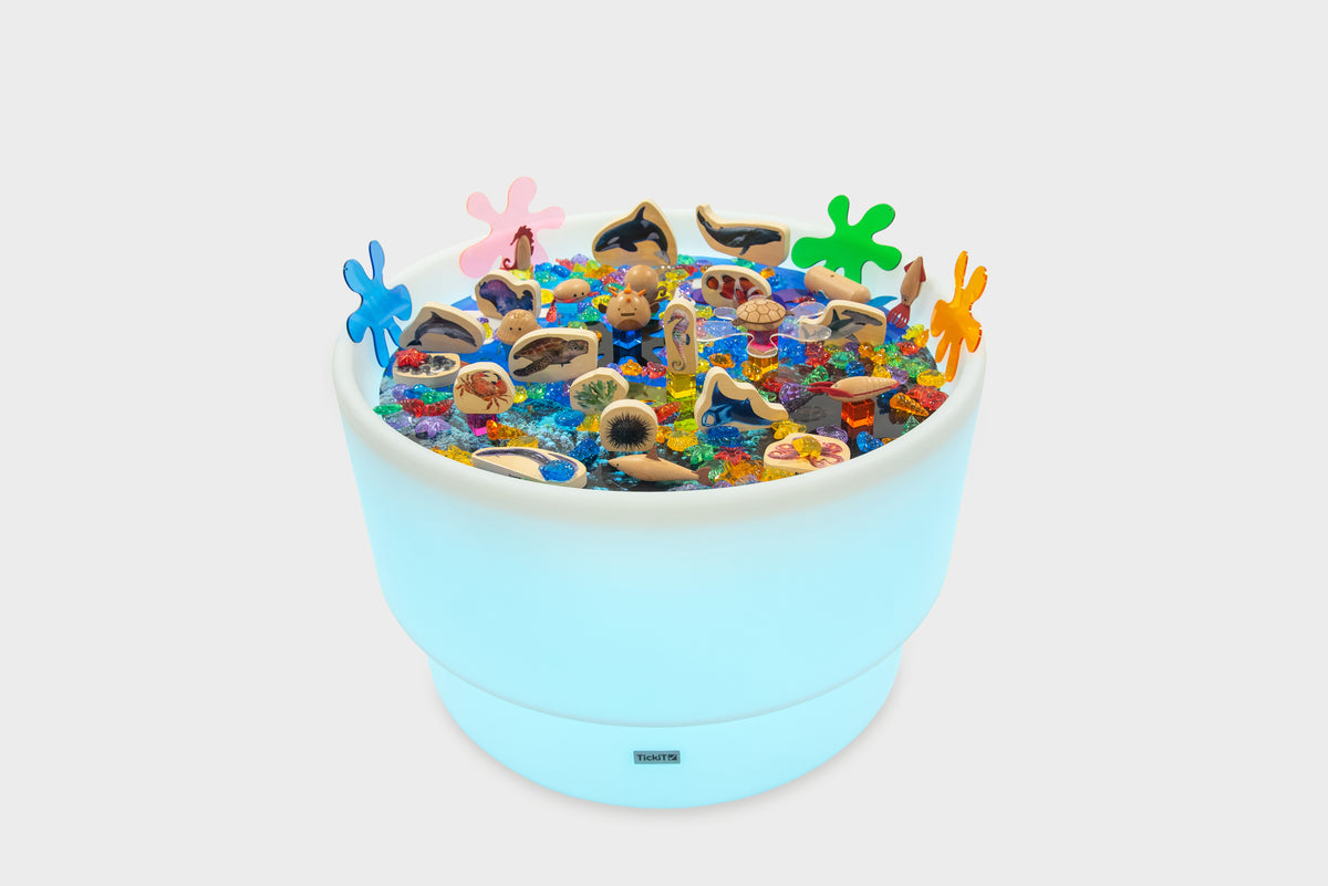 Pastel blue sea-themed table bundle filled with ocean animal toys and shells