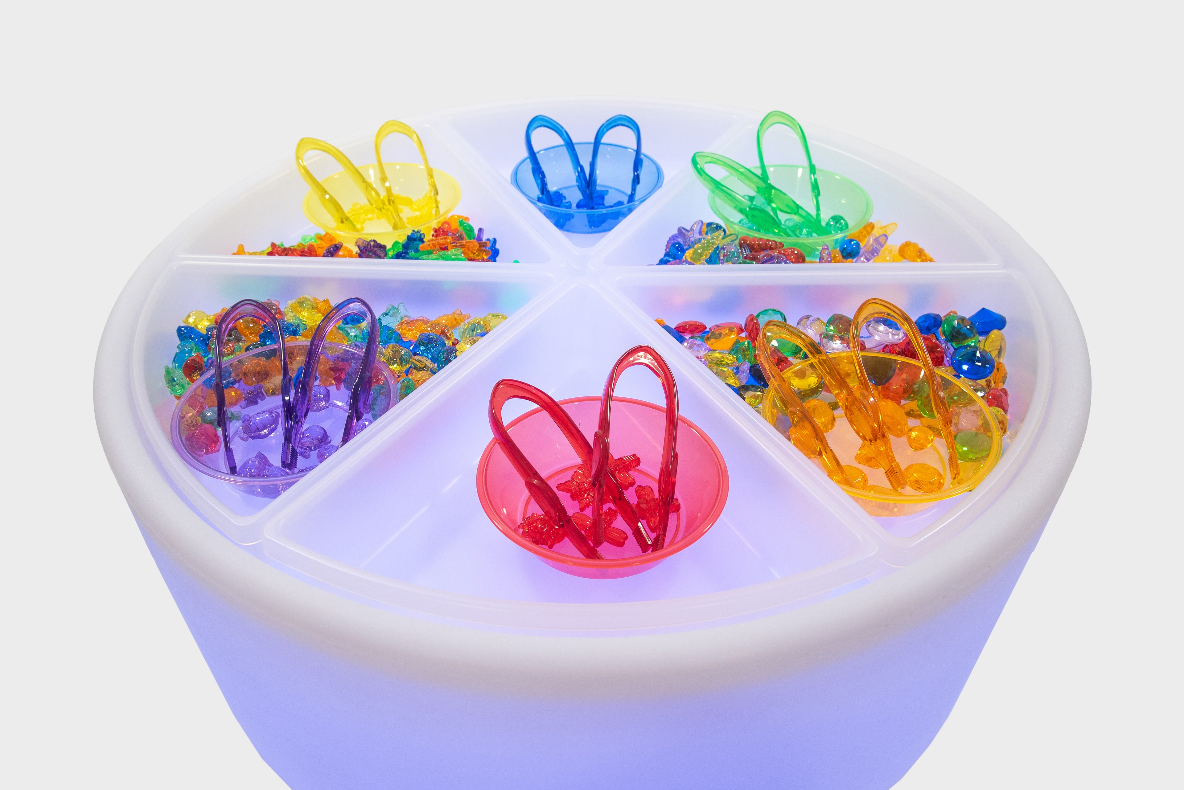 Round sorting table with clear top showing five colorful bins and handle grips