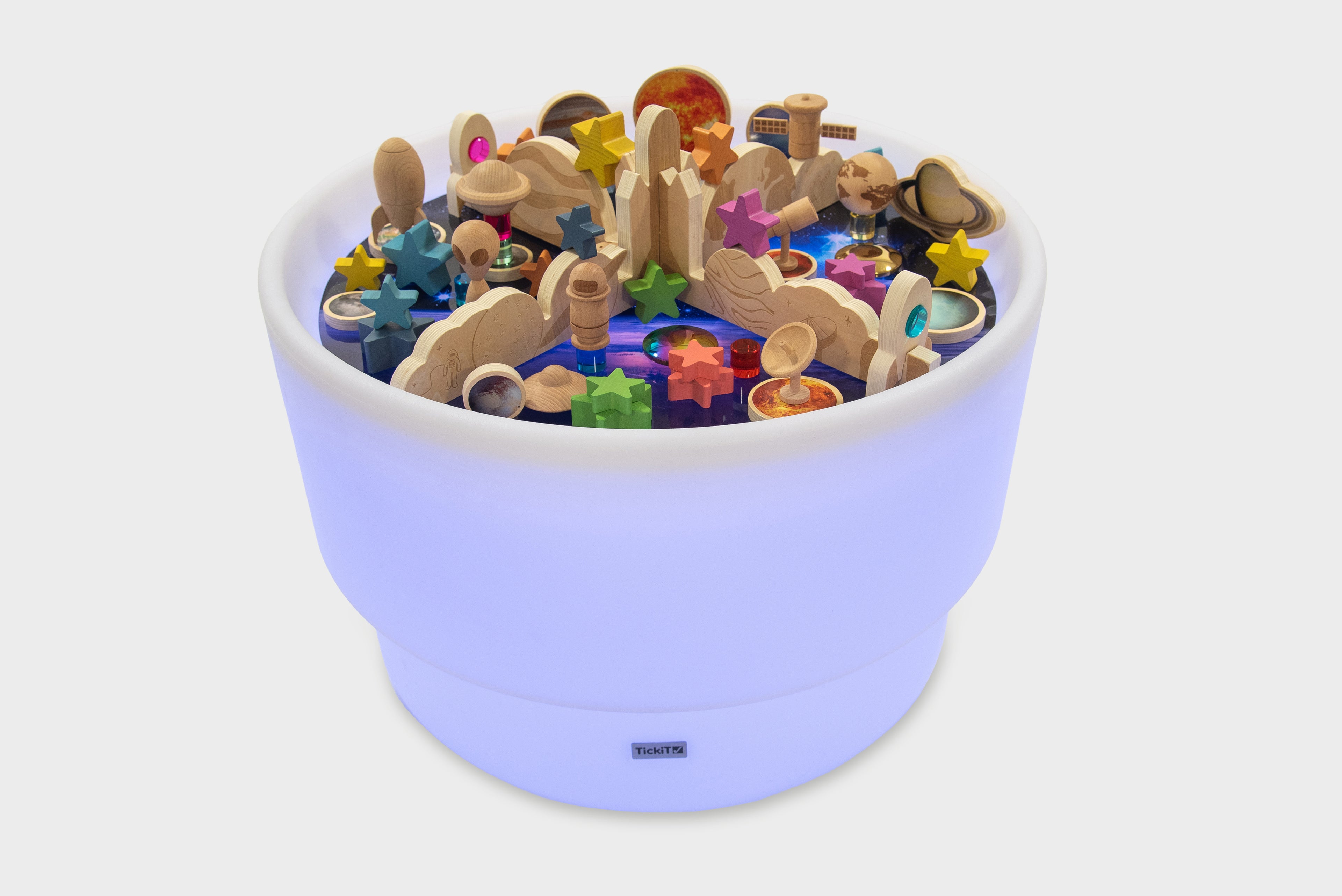 Purple glowing space play table with wooden planets, star shapes, and blocks