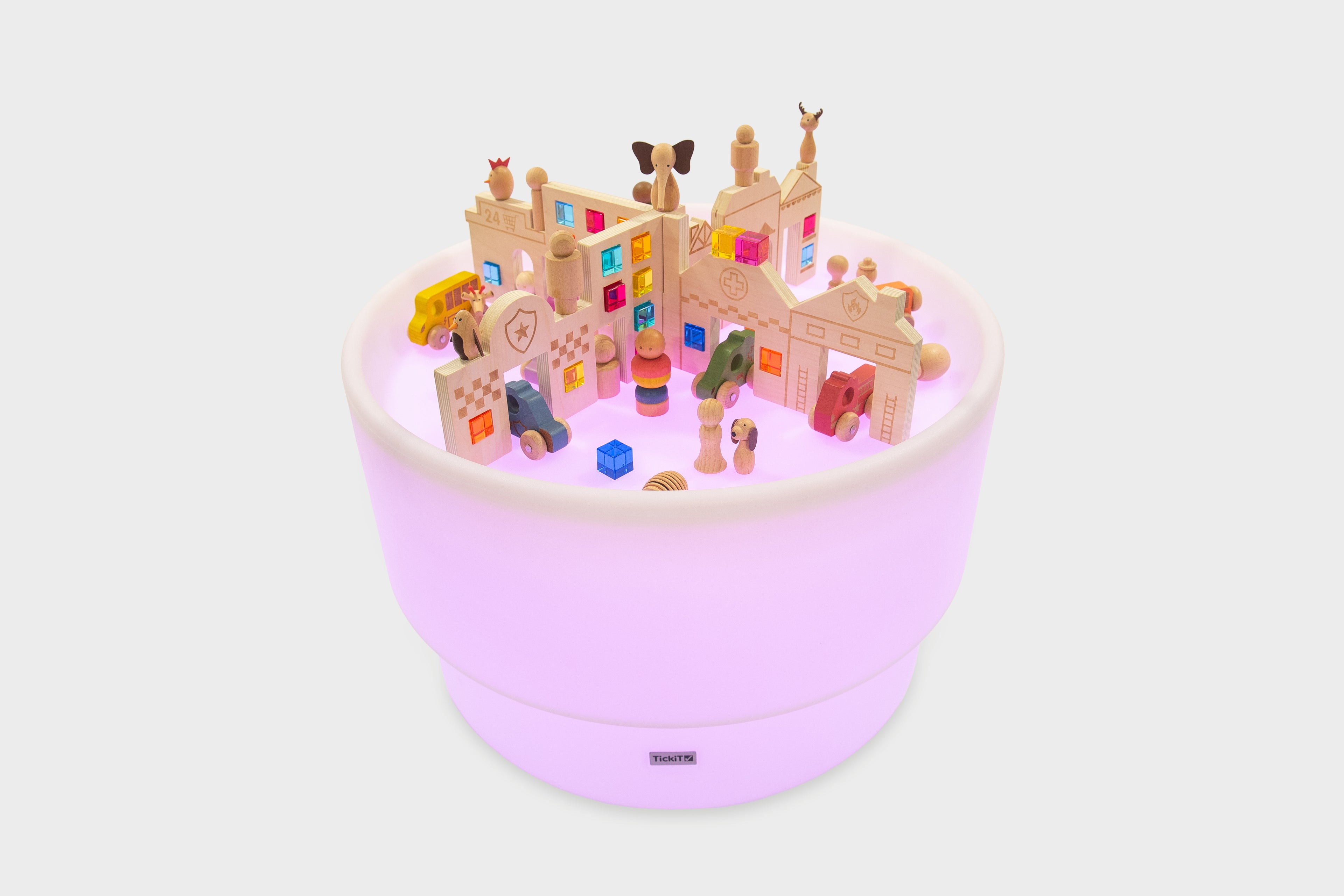 Miniature town playset inside round light-up table with buildings, vehicles, and figures
