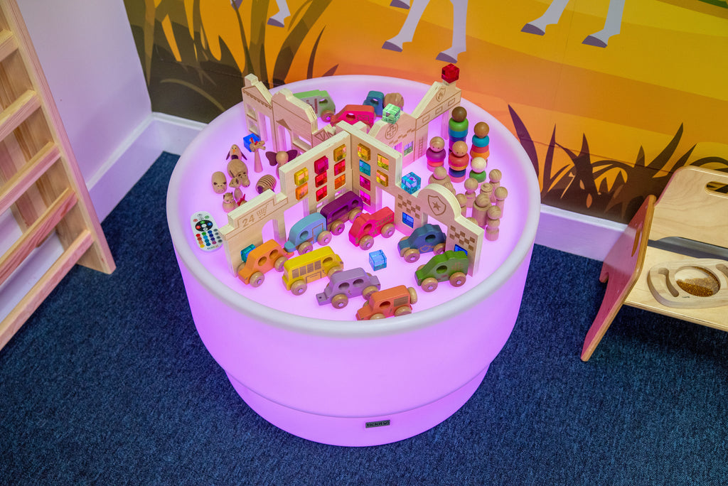 Miniature town inside round light-up Discovery Town play table with buildings and vehicles