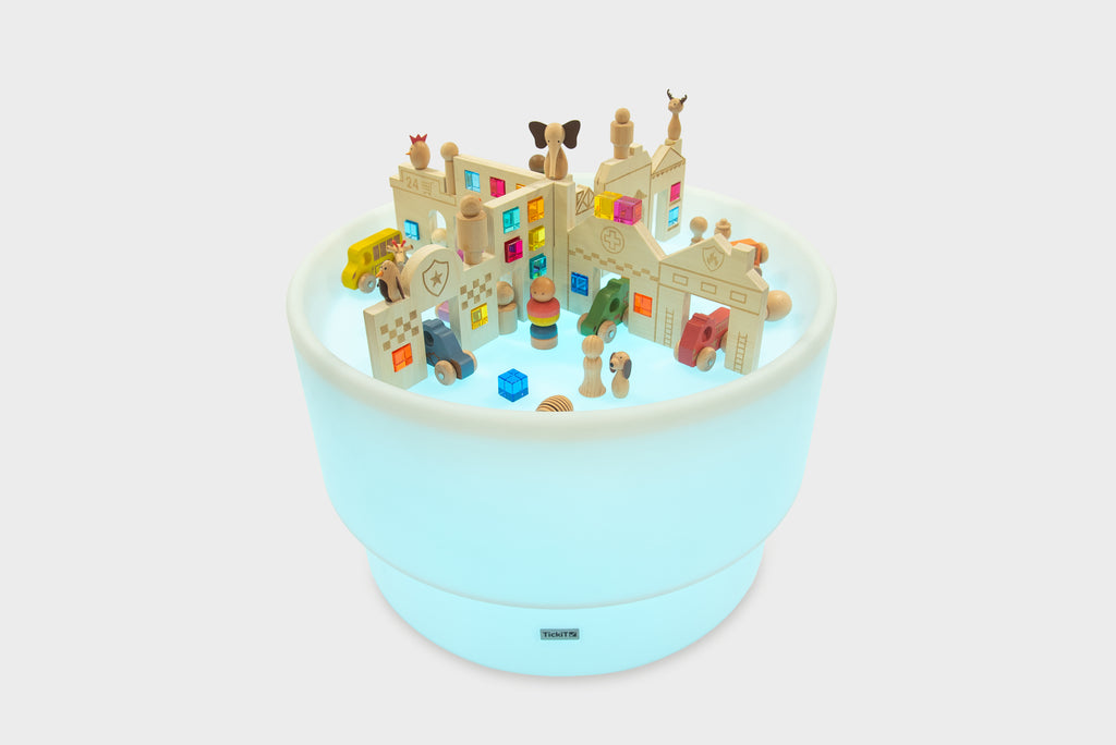 Round light-up play table featuring a miniature town with colorful buildings and figures