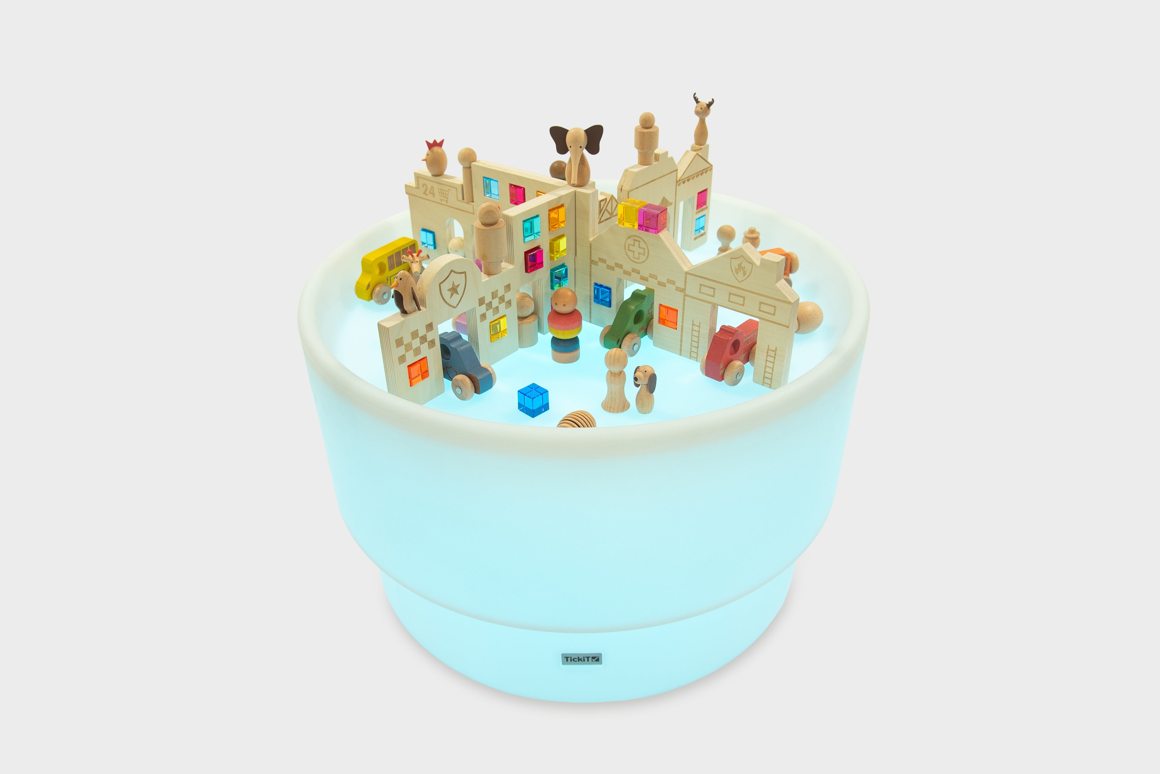 Round light-up play table featuring a miniature town with colorful buildings and figures