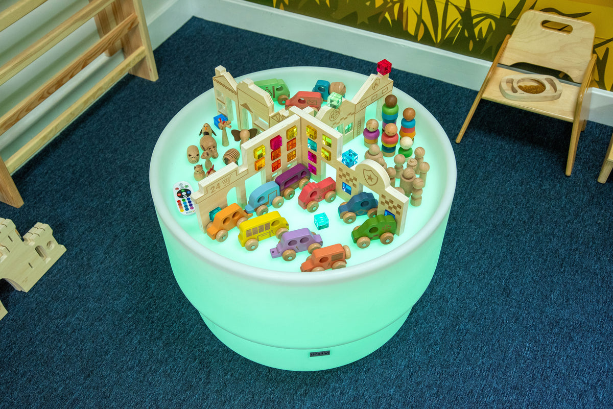 Top view of Discovery Town play table featuring miniature town roads, buildings, and vehicles