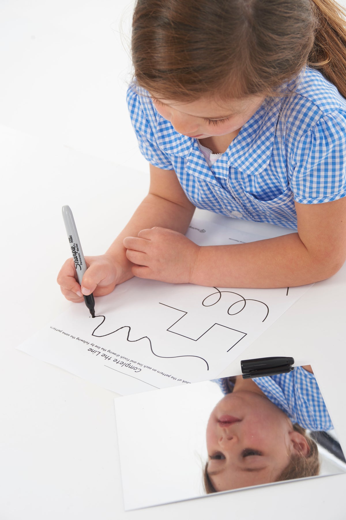 Rectangular double-sided mirror board as child draws with marker