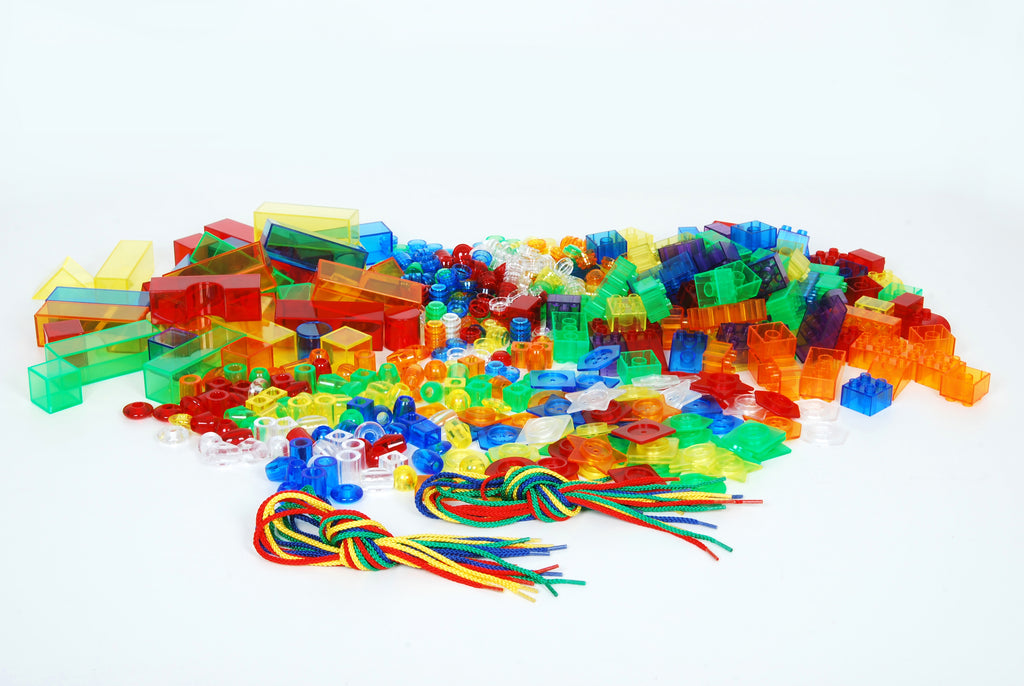 Large pile of multicolor translucent building blocks, rods, and colored cords