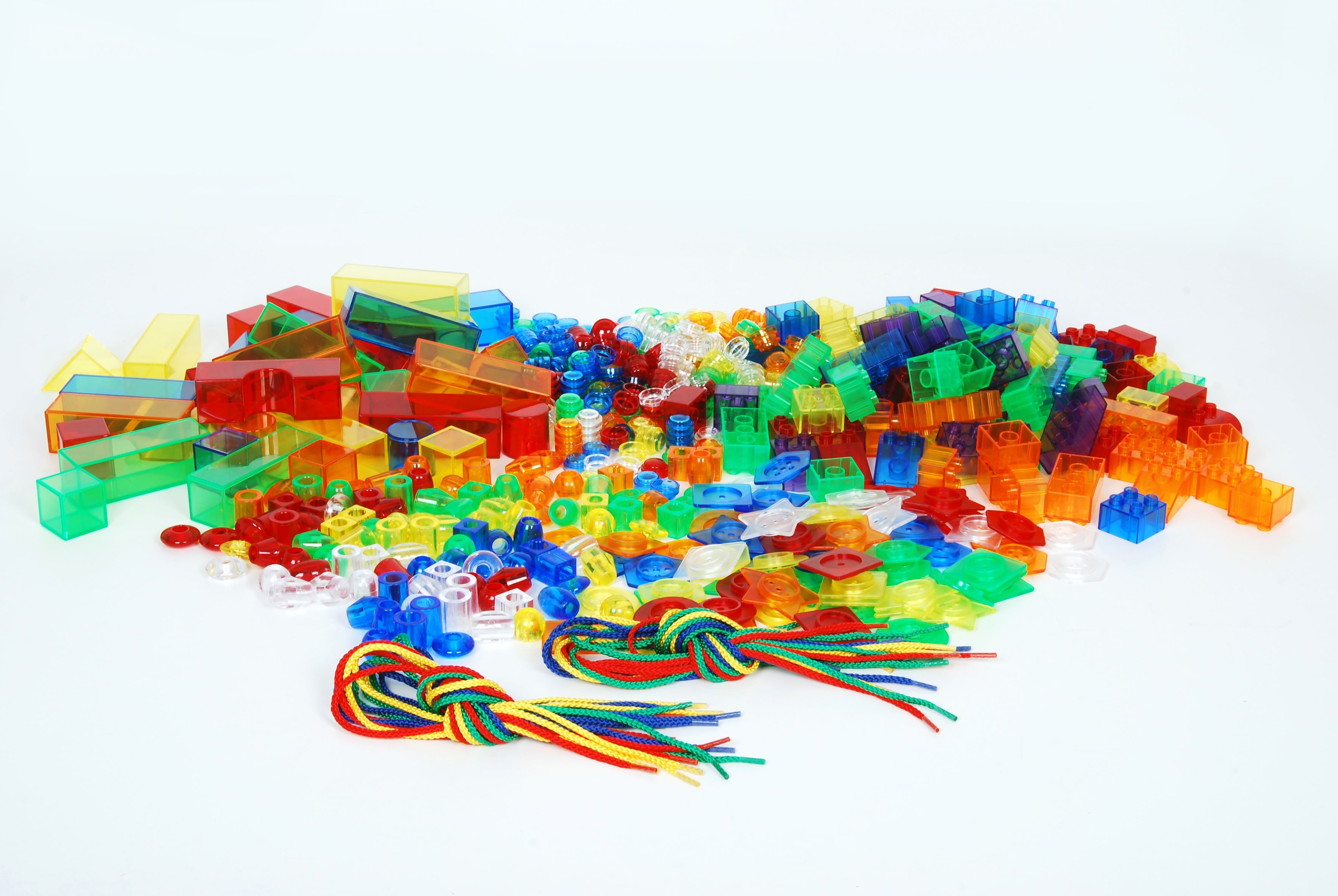 Large pile of multicolor translucent building blocks, rods, and colored cords