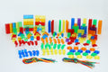 Assorted multicolor plastic building pieces, rods, cylinders, and colored cords