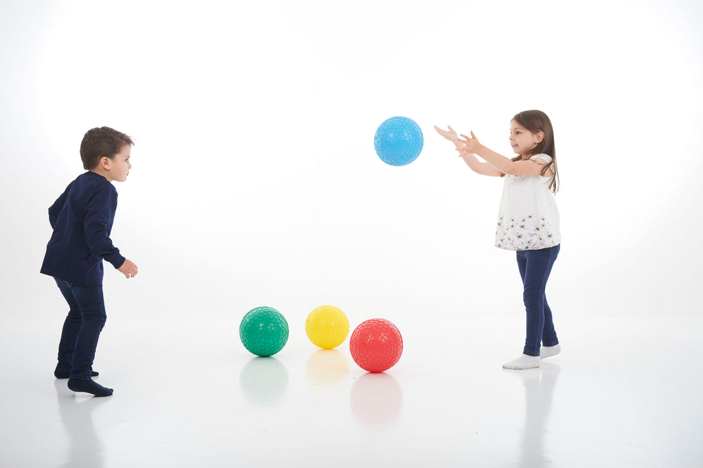 Four textured grip balls: blue, green, yellow, and red