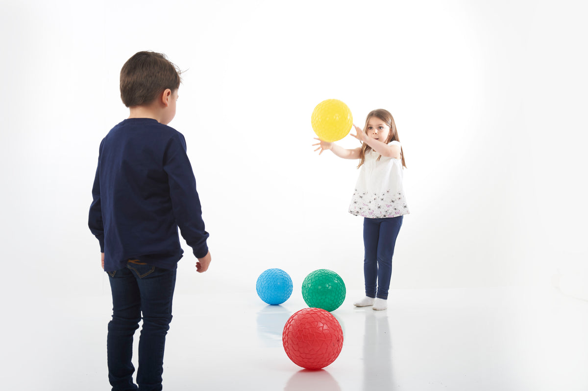 Set of 4 textured grip balls clustered: blue, green, red, and yellow