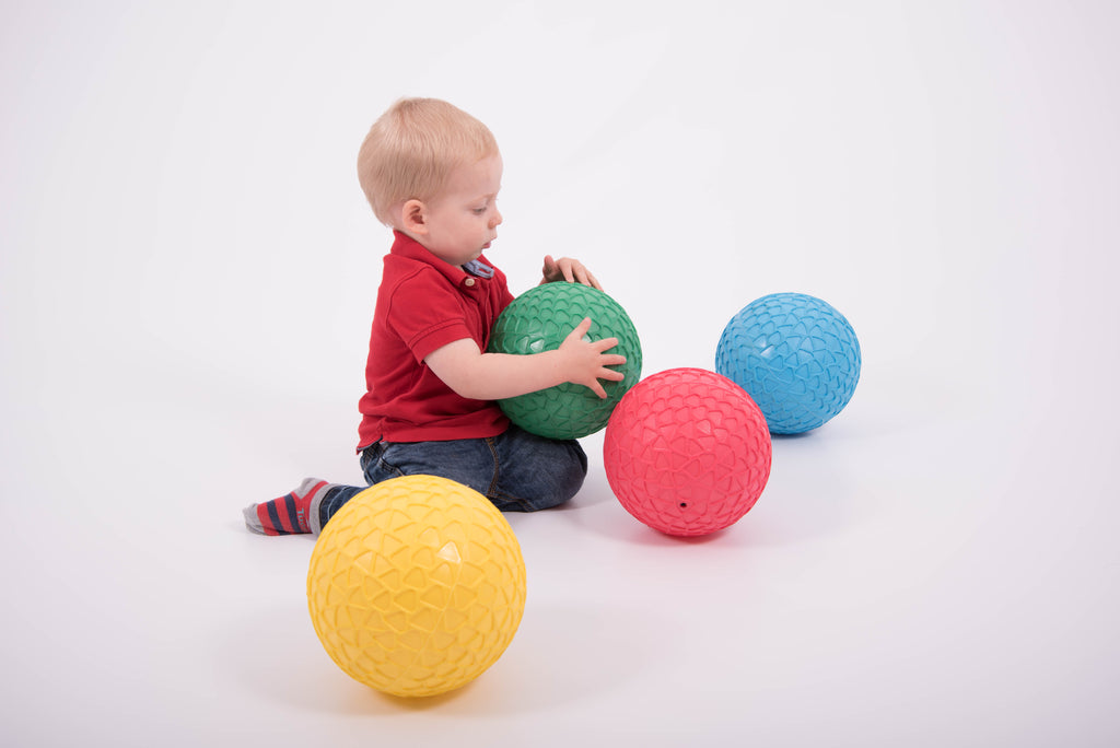 Set of 4 textured grip balls: green, blue, red, and yellow, round and bumpy
