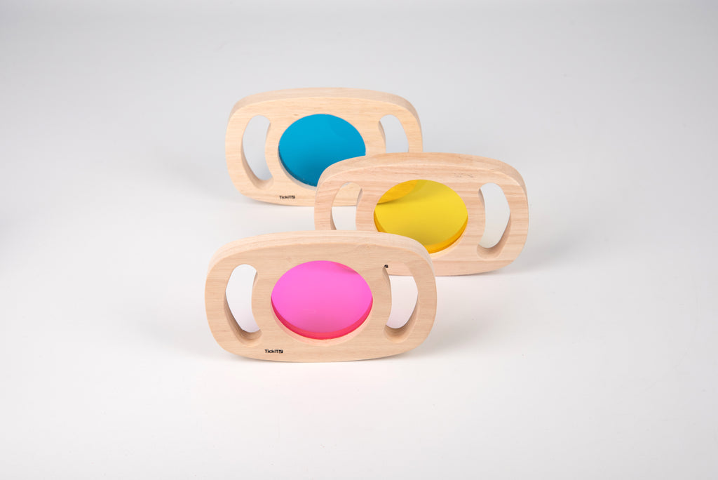 Wooden color panel frames with translucent blue, yellow, and pink windows on display