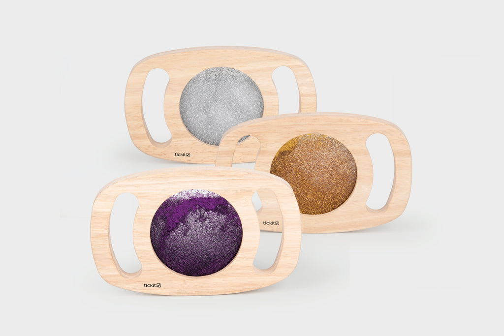 Wood glitter panel set with three oval frames and gray, gold, and purple sparkly inserts