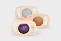 Wood glitter panel set with three oval frames and gray, gold, and purple sparkly inserts