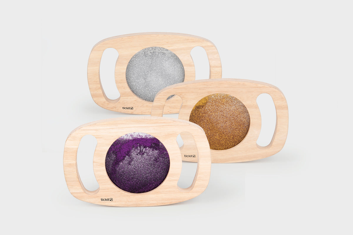 Wood glitter panel set with three oval frames and gray, gold, and purple sparkly inserts