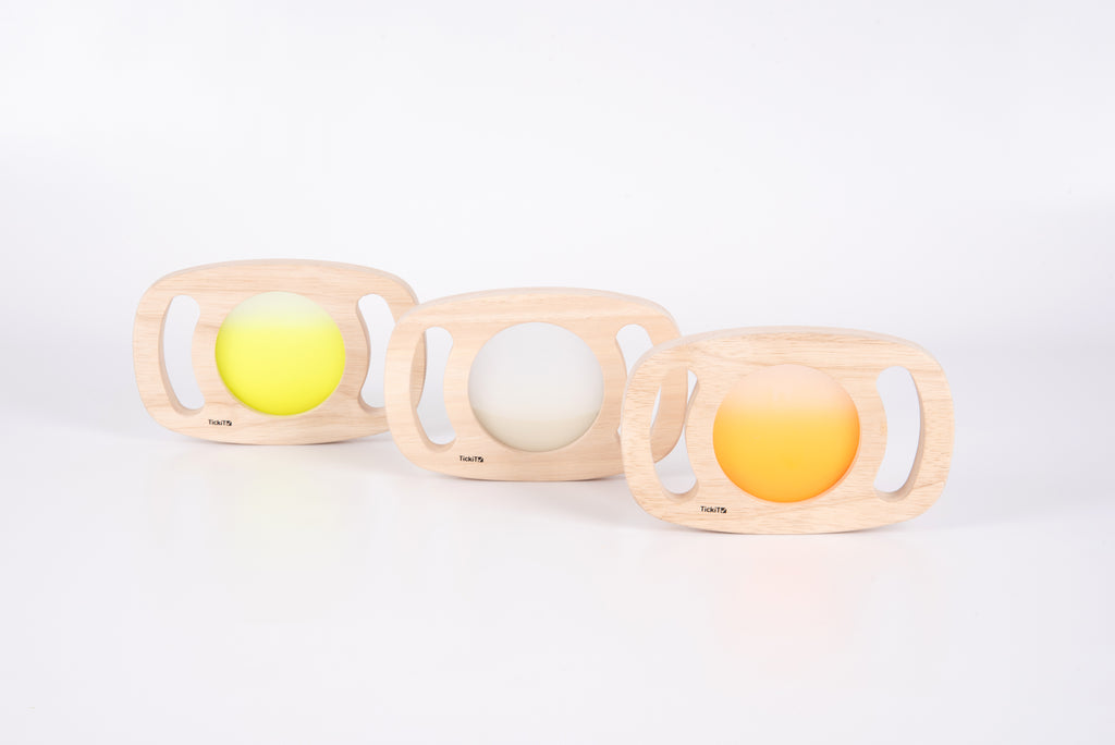 Three wooden glow panels with yellow, clear, and orange illuminated discs
