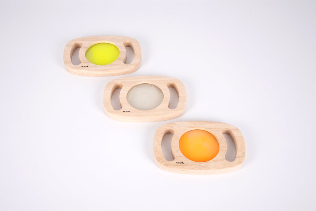 Three wooden glow panels with yellow, clear, and orange illuminated discs