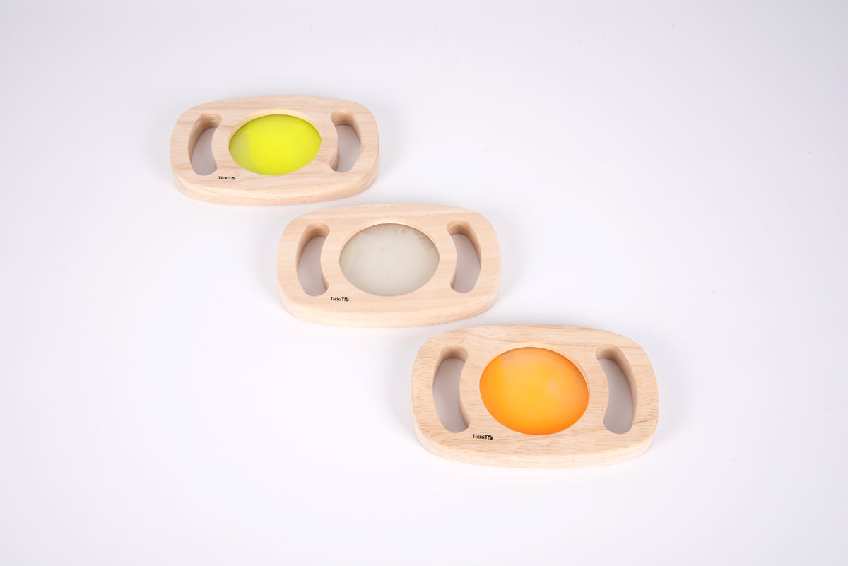 Three wooden glow panels with yellow, clear, and orange illuminated discs