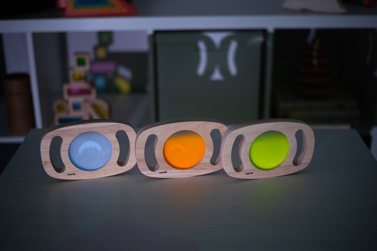 Set of three wooden glow panels with blue, orange, and green illuminated discs